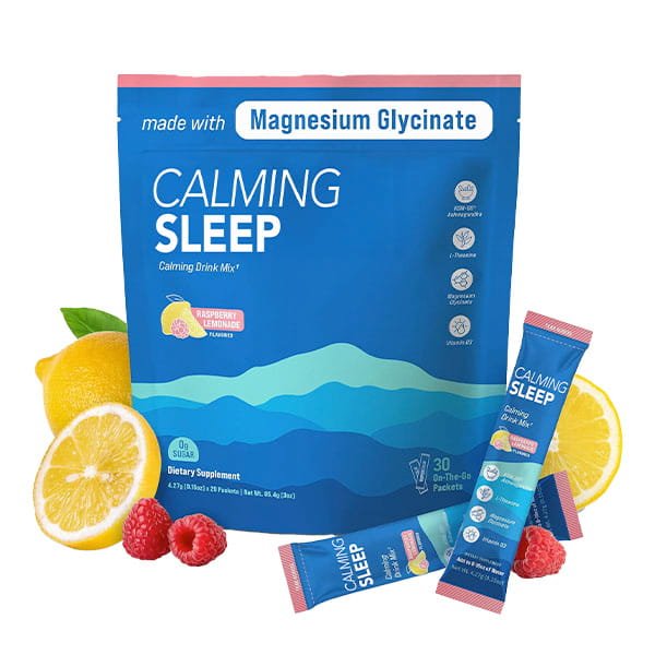 A blue bag labeled "Calming Sleep (Includes 30 Packs)" calming drink mix in Raspberry Lemonade flavor is displayed alongside raspberries, lemon, and two single-serve packets. The packaging highlights magnesium glycinate and ashwagandha as key ingredients for restful relaxation.