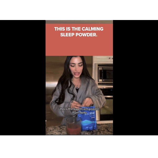 A woman stands in a kitchen, holding a blue packet labeled Calming Sleep above a glass. Text above her reads, THIS IS THE CALMING SLEEP POWDER made with magnesium glycinate and ashwagandha (Includes 30 Packs).