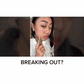 A person points to acne on their cheek with the text breaking out? overlaid, illustrating the need for Dr. Leo Acne Buster spot treatment.