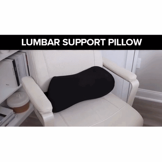 A Lumbar Support Pillow for Chair in black memory foam sits on a white office chair near a desk and bookshelf. "LUMBAR SUPPORT PILLOW" is displayed at the top of the image.