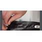 Close-up of hands opening a resealable black plastic bag, pulling apart the zip lock at the top edge. The packaging, designed for PowerRoast™ Protein + Creatine Coffee, features a white label with the number 24 partially visible on the right side of the bag.