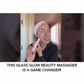 A woman wearing a pink headband uses the Real Glass Glow Beauty Massager on her face for pore care. Text below reads: THIS REAL GLASS GLOW BEAUTY MASSAGER IS A GAME CHANGER!.