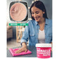 A woman smiles while using All-Purpose Cleaning Paste to wipe a table with a pink cloth, with an inset showing the paste’s texture.