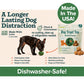 A black dog plays with the Dog Treat Toy With Refill Treats in green. The packaging is shown, highlighting that it is dishwasher-safe, made in the USA, and extra long lasting. Text on the package describes features and convenience, including Long Lasting Dog Chews for hours of satisfaction and Peanut Butter Dog Treats for a flavor your pup will love.