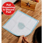 A person pulls the drawstring on a Drawstring Pee Pad (Includes 25 Pads), which has a wet spot in the center. Text in a red circle reads, "Pull Drawstring to Discard Pad!" The leak-proof pet pad is placed on a wooden floor near a box with a star cutout.