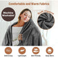 A woman wraps herself in a dark gray Electric Heated Shawl, with text labels highlighting its machine-washable, soft fleece fabric and icons indicating it is lightweight, skin-friendly, and warm.