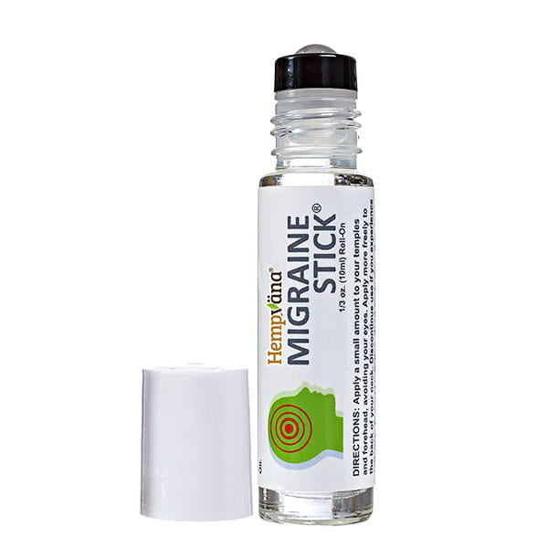 A clear roller bottle labeled “Hempvana Migraine Stick” stands beside its white cap. The label displays directions and features a green graphic of a head with red rings at the temple, emphasizing this migraine relief roll-on infused with soothing hemp seed oil.