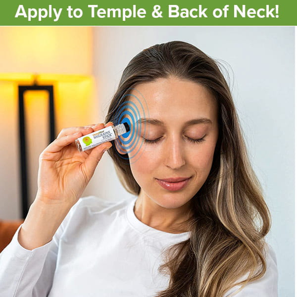 A woman applies the Hempvana Migraine Stick to her temple, eyes closed, with a green banner above that says, “Apply to Temple & Back of Neck!” A lamp is visible in the background. This natural formula contains soothing hemp seed oil for effective migraine relief.