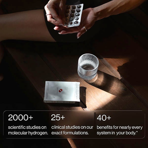 A person opens a blister pack of Molecular Hydrogen Water Drinking Tablets next to a glass of water and the product box. Overlay text highlights: 2000+ hydrogen studies, 25+ clinical trials, and 40+ systemic health benefits—demonstrating the science behind molecular hydrogen for enhanced well-being.