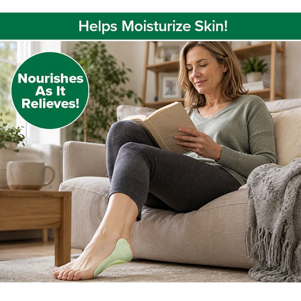 A woman sits on a beige sofa reading a book, with a Hempvana Plantar Fasciitis Pain Relief Patch on her left foot. Text says, Helps Moisturize Skin! Nourishes As It Relieves! The room looks bright and cozy.