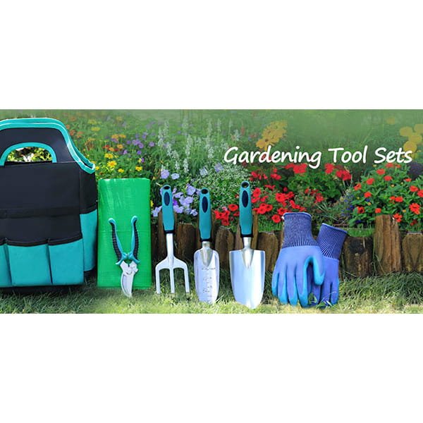 The 7 Piece Gardening Tool Set—with tote bag, kneeling mat, pruning shears, hand rake, two trowels, and blue gloves—makes an ideal gardening gift and is displayed before a vibrant flower bed filled with colorful blooms and lush greenery.