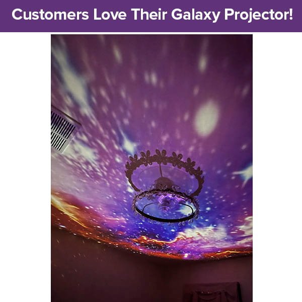 Colorful lights from the Galaxy Projector for Bedroom create a starry, nebula effect on the ceiling around a chandelier. A purple banner at the top reads, “Customers Love Their Galaxy Projector for Bedroom!”.