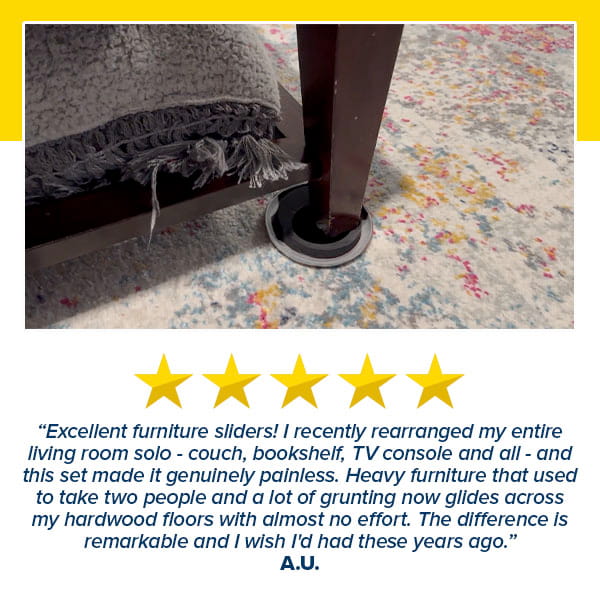 A round Heavy Duty Furniture Slider sits under a dark wooden table leg on a colorful speckled rug, with a five-star review below praising these sliders for making heavy furniture easy and effortless to move.