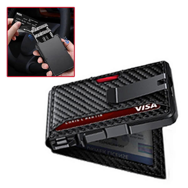 A hand pulls a card from the Slim Compact RFID Wallet—constructed in black carbon fiber with a money clip—while seated near a car steering wheel; this minimalist wallet securely holds credit cards.