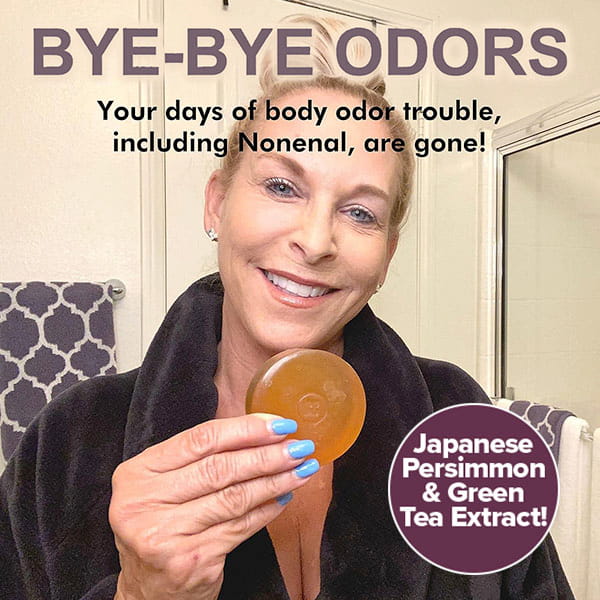 A woman in a robe holds a round, amber-colored Kaori Soap Bar for Old People Smell, with text reading BYE-BYE ODORS and Japanese Persimmon & Green Tea Extract!.