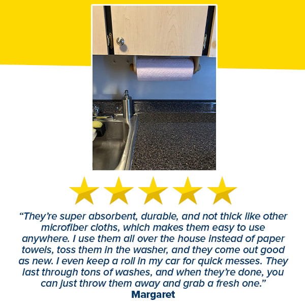 A roll of Reusable Microfiber Cleaning Towels (You Get 75 Towels) hangs under a kitchen cabinet above the sink. Below, Margaret’s 5-star review praises their absorbency, durability, and reusable design.