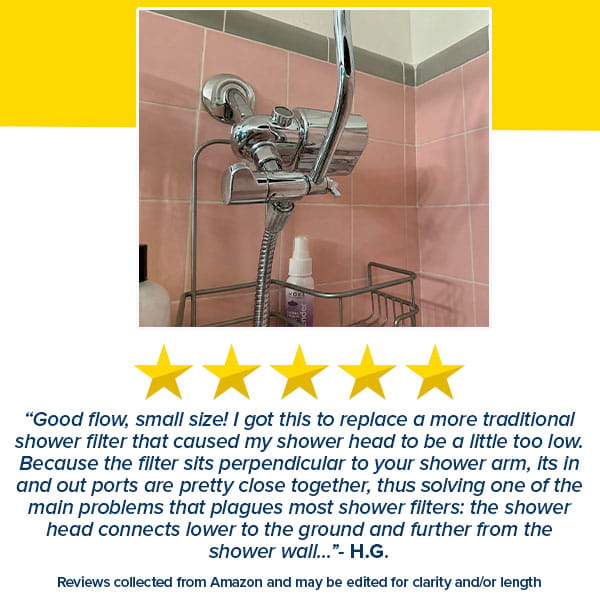 A 5-star review for the Shower Filter for Natural Skin & Healthy Hair highlights its compact design, effective chlorine filtration, and improved shower head placement for healthier hair. The chrome filter is mounted on a pink tiled wall above a shower caddy.