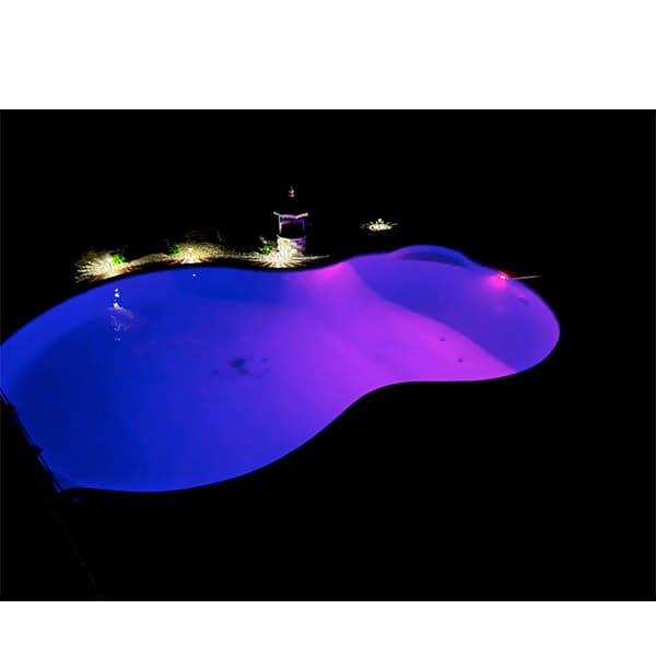 At night, a kidney-shaped pool glows with shimmering blue and purple Solar Pool Lights for Inground & Above Ground Pool, while small garden lights softly illuminate the edges against the darkness.