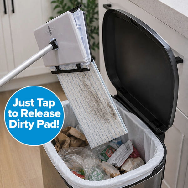 Using its convenient foot tap-lock system, the Tap Mop allows you to release a dirty pad hands-free into a kitchen trash can. A blue circle highlights the message, “Just Tap to Release Dirty Pad!” while trash and packaging are visible in the bin below.