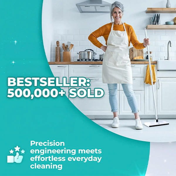 A smiling woman in an apron stands in a modern kitchen holding a Tap Mop. Text reads “BESTSELLER: 500,000+ SOLD” and “Precision engineering meets effortless everyday cleaning with a foot tap-lock system.”.