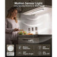 A woman prepares food in a kitchen lit by the 3-Pack Under Cabinet Lighting With Charging Station, featuring motion sensor activation, a 120° detection angle, 10-foot sensing range, and a 20-second auto-off for convenient modern lighting.