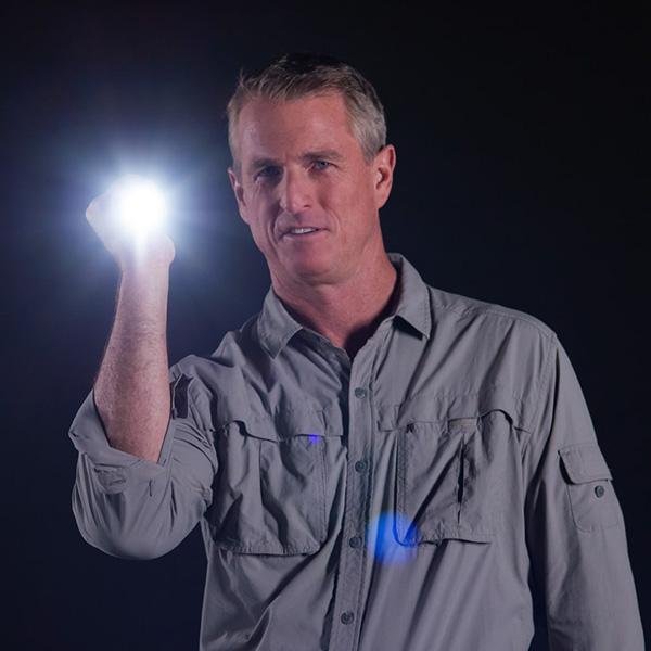 Demonstration of Atomic Beam Flashlight. Man holding Atomic Beam Flashlight shining it directly at the camera