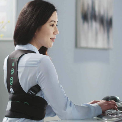 A woman wearing Hempvana Arrow Posture while typing on a keyboard