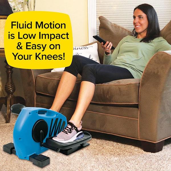 Woman sitting on couch holding tv remote using Blu Tiger on the floor. Text says "Fluid Motion is Low Impact & Easy On Your Knees!"
