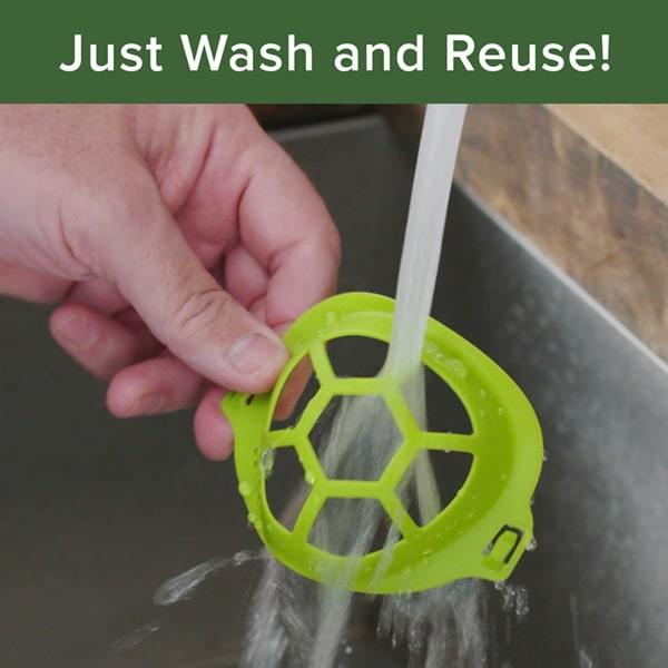 Close up of woman's hand holding a Cool Turtle under running water. Headline says "Just Wash and Reuse"