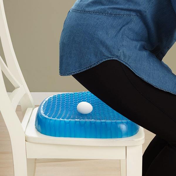 Egg Sitter Support Cushion on chair with an egg on it and woman is about to sit on it