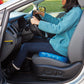 Woman sitting on Egg Sitter Support Cushion in driver's seat of a car