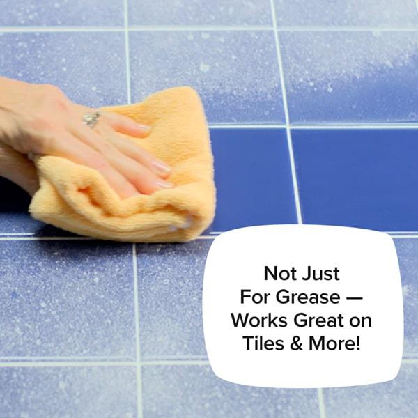 Woman's hand wiping scummy tile; Not just for grease - works on tiles and more