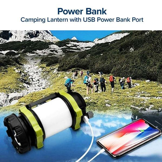 A smart phone is charging from the USB port in the power bank. A family hikes up green mountains with snowy peaks in the background.