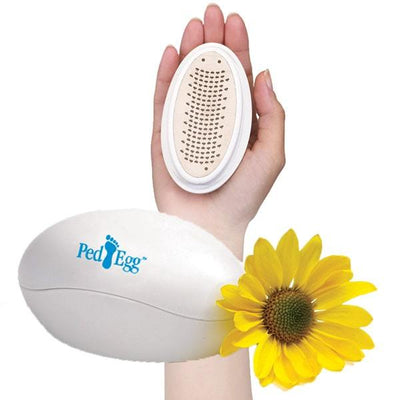 A PedEgg, a sunflower, and a person holding a PedEgg in their hand isolated on a white background