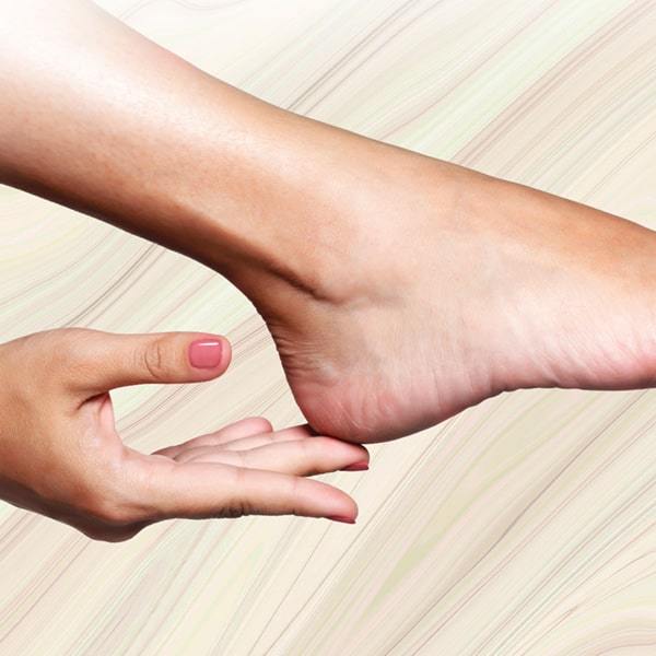 Woman touching heel
