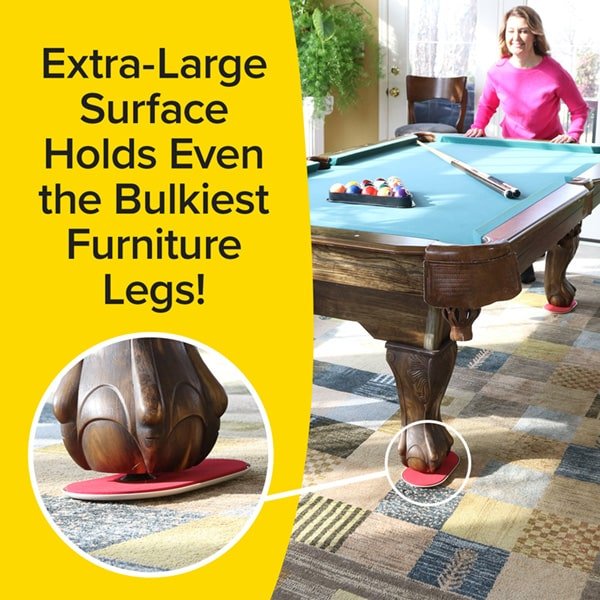 lady in a pink shirt  in a room with a pool table.  there are ruby slider units under the pool table legs. there is a text overlay reading extra-large surface holds even the bulkiest furniture legs!"