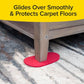 image of the bottom corner of a couch with a hand placing a red ruby mover unit under the couch leg on top of a rug. there is black text over a yellow banner on top of the image with text that reads "glides over smoothly & protects carpet floors"