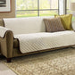 Beige Couch Coat laid on a couch with two pillows on it