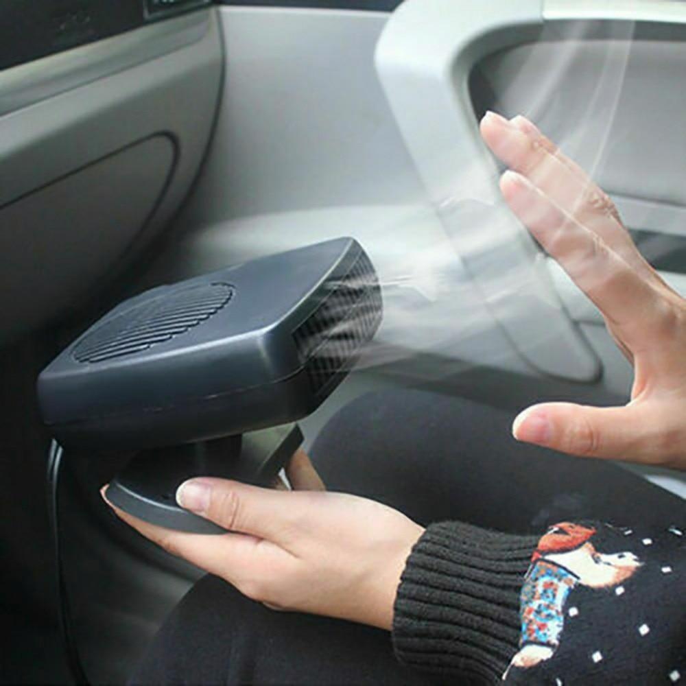 Car Heater being used to warm woman's hand in car